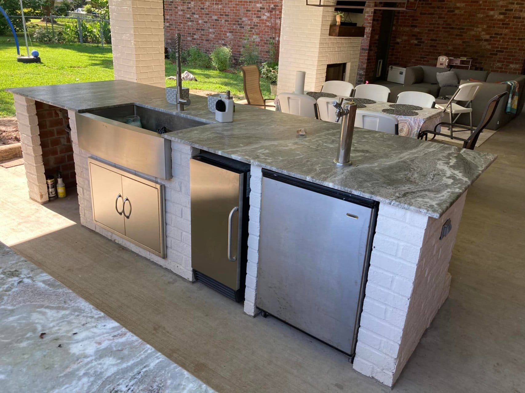 outdoor kitchen island with sink and beer tap