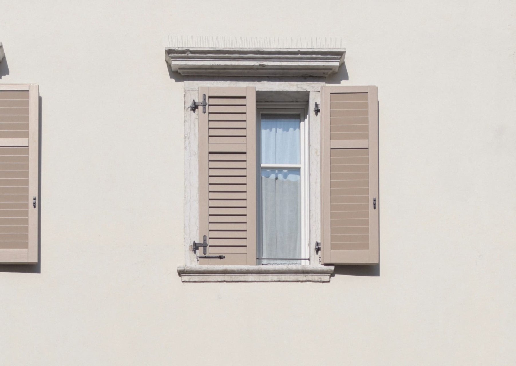 Window on a house with shutters.