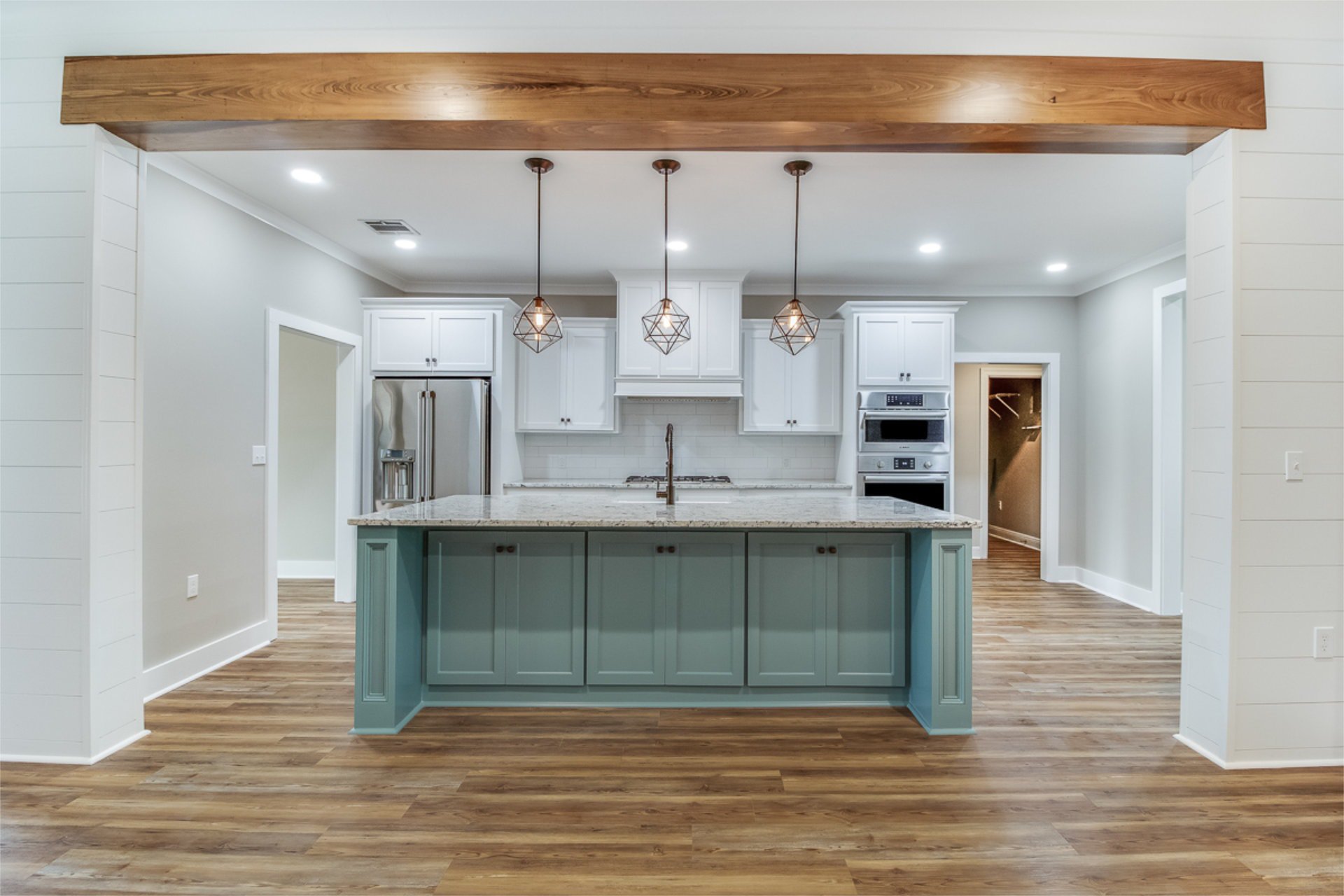kitchen island with three pendants hanging over