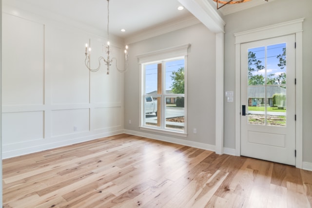 an empty room with hardwood floors and white walls.