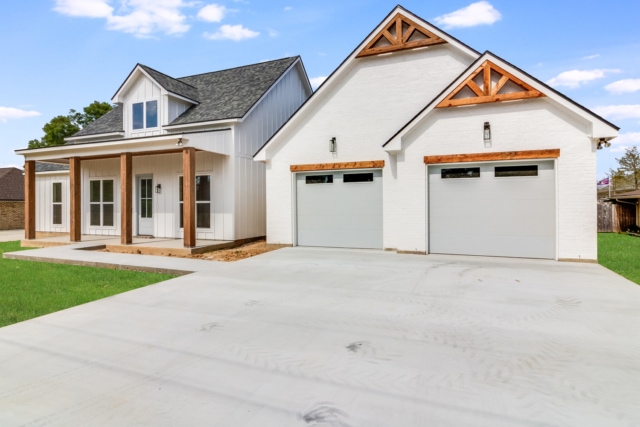 a home with two garages and a driveway.