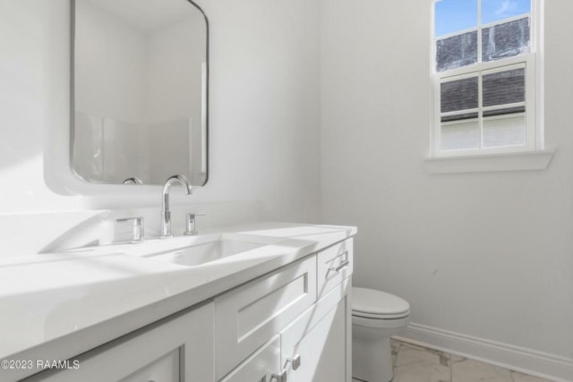 a white bathroom with a window and sink.