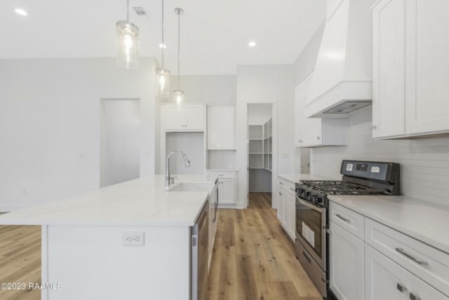 a kitchen with white cabinets and hardwood floors.