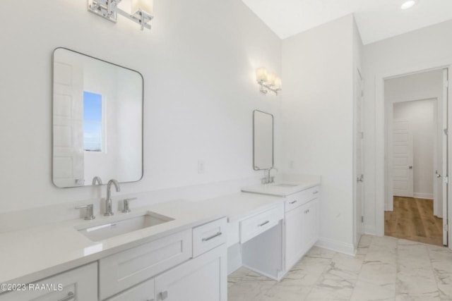 a white bathroom with two sinks and a mirror.