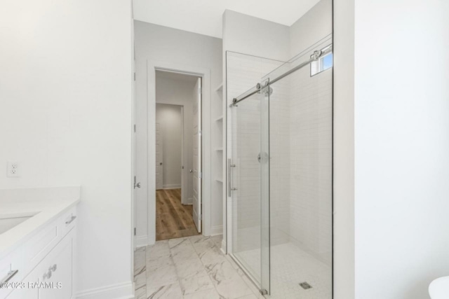 a white bathroom with a glass shower stall.