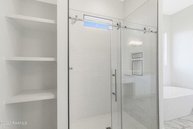 a white bathroom with a glass shower door.
