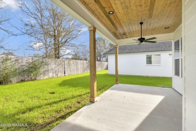the front porch of a home with a ceiling fan.