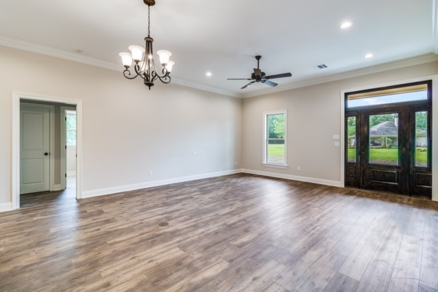 empty living room with hardwood floors and a ceiling fan.