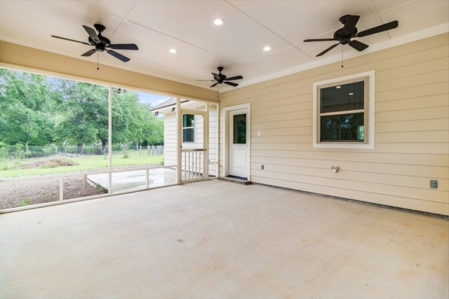 a screened in porch with ceiling fans and a sliding glass door.