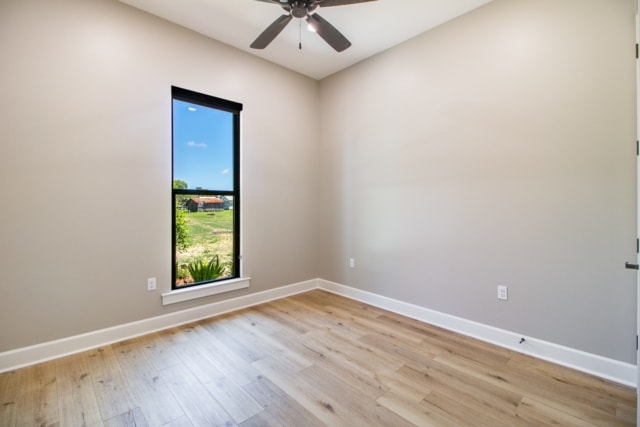 an empty room with hardwood floors and a ceiling fan.
