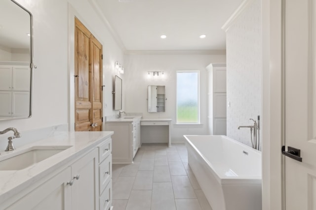 a white bathroom with two sinks and a tub.