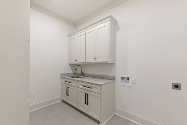 a laundry room with white cabinets and counter tops.
