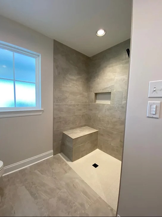 a bathroom with a toilet, sink and shower.