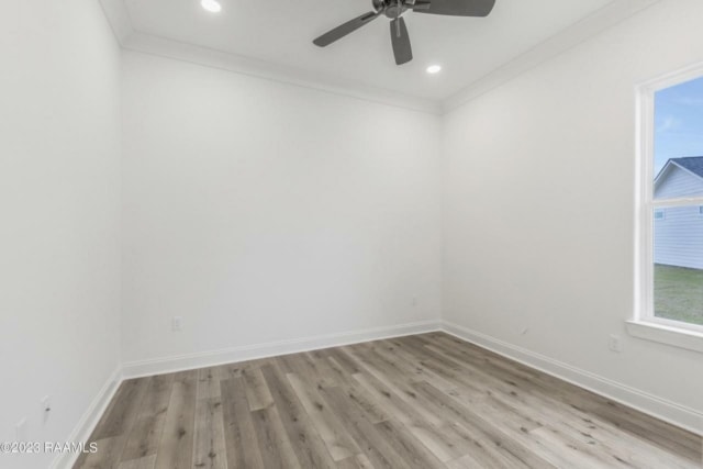 an empty room with white walls and a ceiling fan.