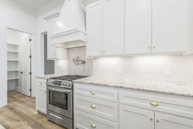 a kitchen with white cabinets and granite counter tops.