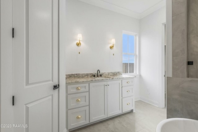 a bathroom with white cabinets and granite counter tops.