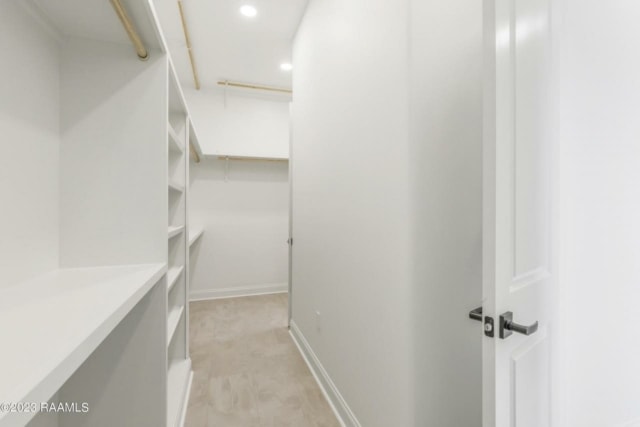 a white closet with shelves and a door.