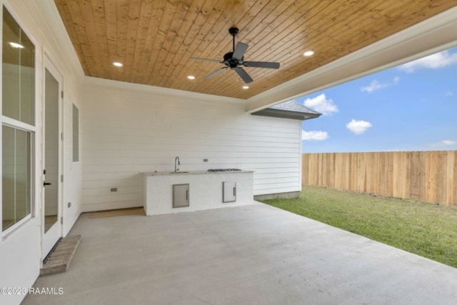 a backyard with a ceiling fan and a sink.