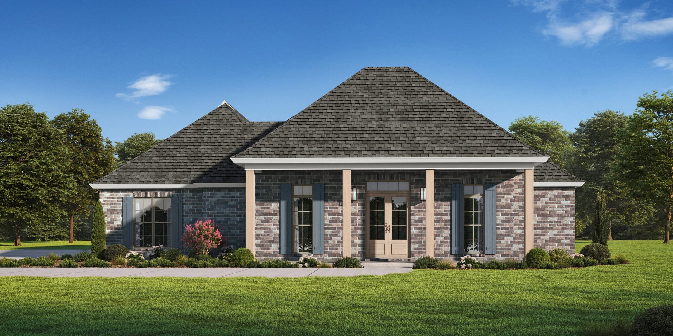 Single-story brick house with a gray shingle roof, four front columns, large windows, and a wooden double door. The house is surrounded by grass, bushes, and trees under a blue sky with scattered clouds.