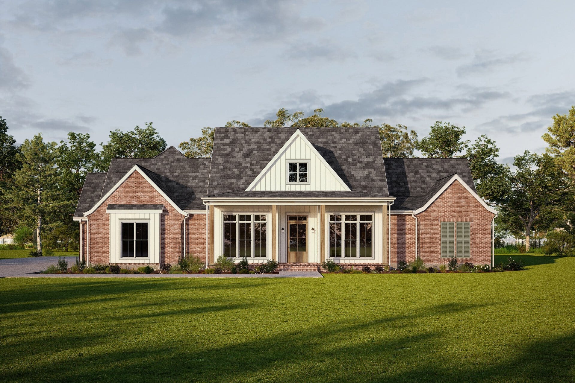 A one-story brick house with a steep, dark gray roof, white trim, large front windows, and a covered porch, set on a grassy lawn with trees in the background under a partly cloudy sky.